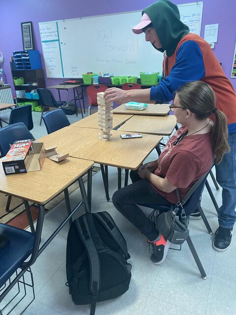 Two Eastlake High School students play a game of Jenga tumbling blocks together in a classroom